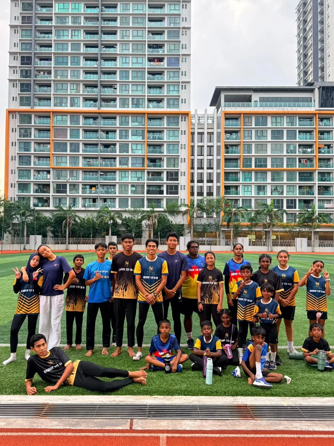 The Kelab Olahraga Setiawangsa squad together on the pitch at Sky Arena Stadium, juniors and seniors in club kit