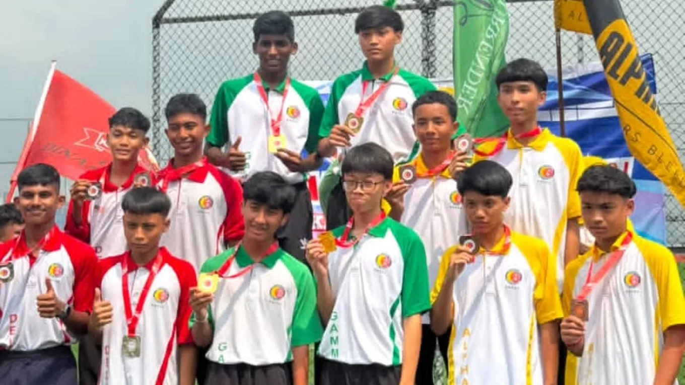 Athletes holding their medals up to the camera, house flags behind them